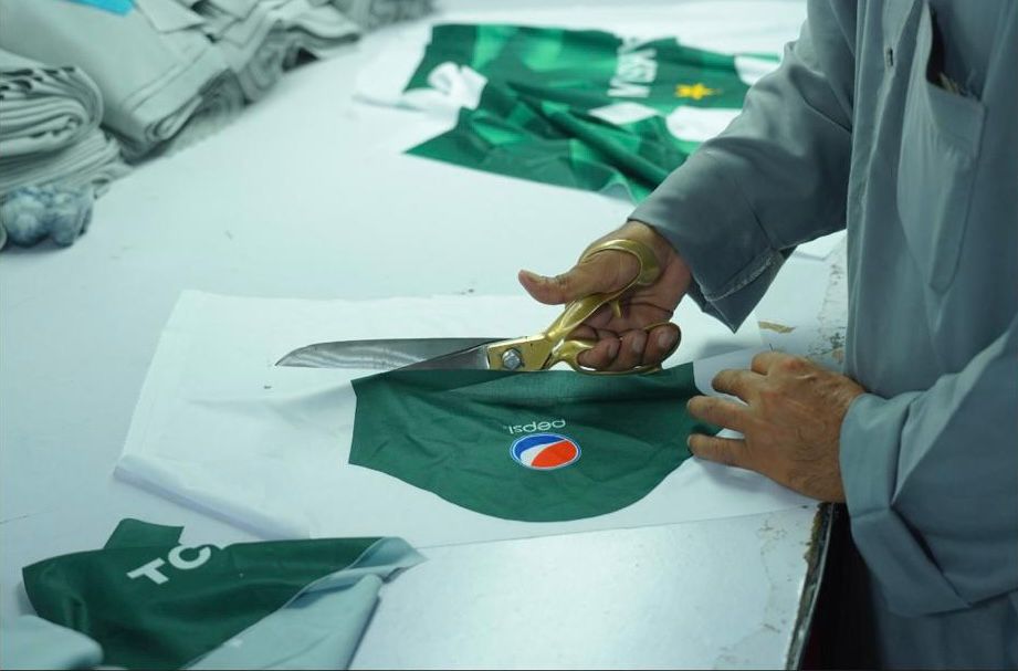 ERA craftsman cutting fabric panels with precision scissors